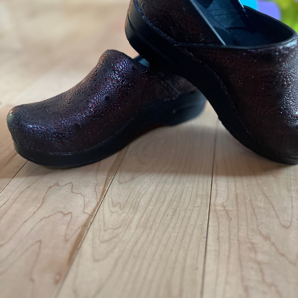 Worn one time red textured dansko clogs.